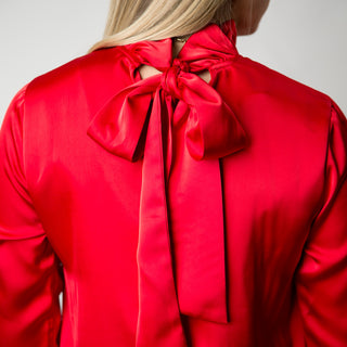 Red dress with ruffle high neck and ribbon tie in the back