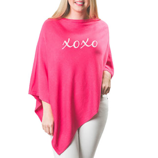 pink poncho with "xoxo" in white letters