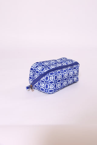 Blue geometric print glam bag with white zipper – stylish organizer