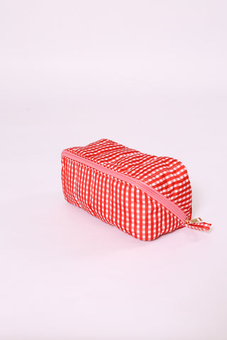 Bright red gingham glam makeup and toiletry bag with zipper.