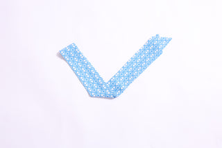 Blue patterned twillie with diamond floral motifs, versatile hair and bag accessory.