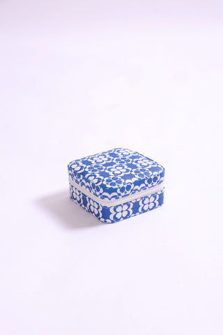 Travel jewelry case with blue and white mosaic-inspired pattern, compact with zipper closure.