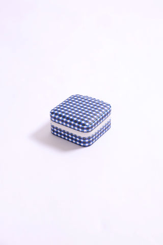 Classic navy gingham print portable jewelry box with compartments inside.