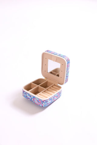 Travel jewelry case with blue and pink paisley print, shown open with mirror and compartments.