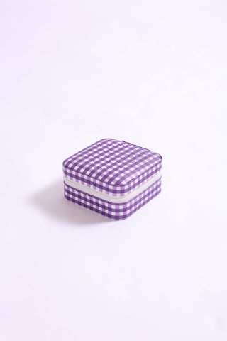 Compact square travel jewelry organizer in purple gingham print with zipper closure.