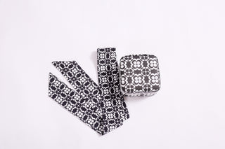 Black and white geometric floral travel jewelry case shown with matching twillie scarf accessory.