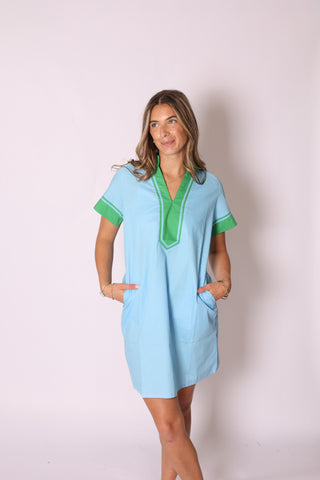 Woman wearing the Candi Color Block Dress in light blue with green accents, standing against a studio backdrop.