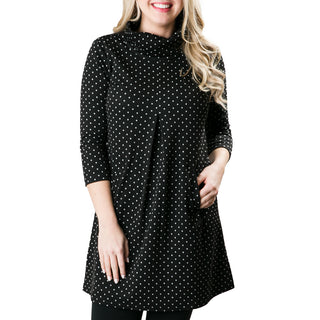 Three quarter sleeve dress with front pleat and pockets in black with white polka dots.