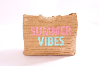 Palma Tote Bag in natural straw with playful embroidered “SUMMER VIBES” text in pink and aqua.