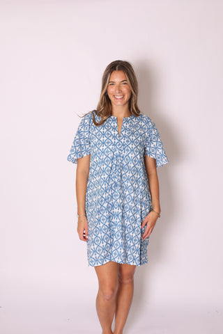 Woman wearing the Romy Mini Dress in blue floral print, short sleeve mini dress with relaxed fit.