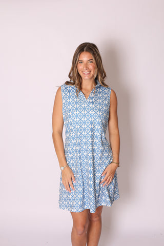 Sleeveless collared dress with blue geometric pattern, styled for spring.