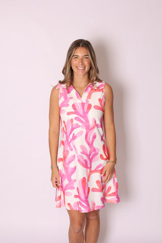 Playful sleeveless collared dress with bold pink coral print on white background.