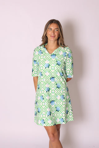 Sage Dress in green and white lattice pattern with blue hydrangea floral accents, half-sleeve style.