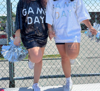 lifestyle shot of a sequins game day dress in white and navy blue