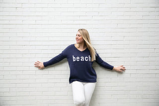 Model wearing blue beach sweater