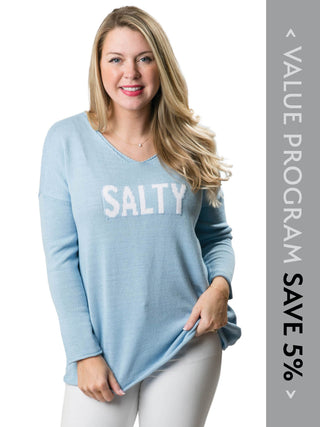 Women wearing blue sweater with the word salty written in white script
