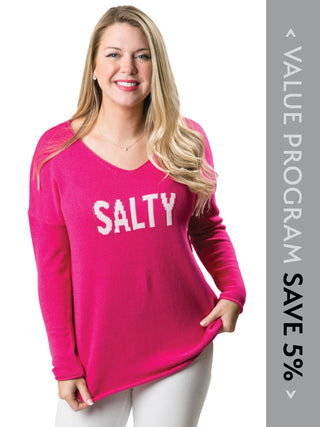 Women wearing pink sweater with the word salty written in white lettering 