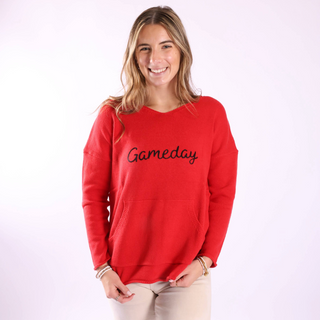 Woman wearing a red 'Gameday' sweatshirt on a white background
