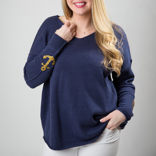 blue sweater with gold sparkle anchor motifs on sleeves