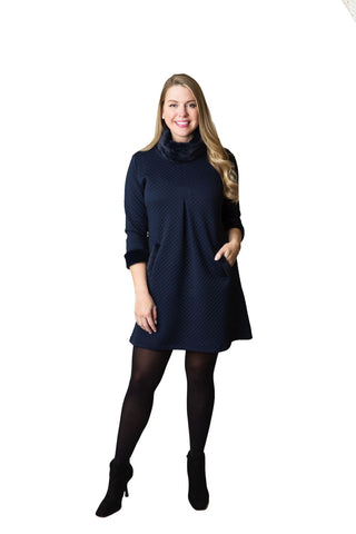 Quilted navy 3/4 sleeve dress with front pleat and pockets with faux fur at neck and cuffs