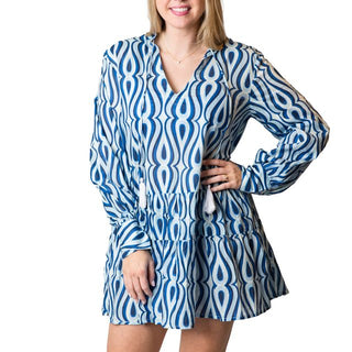 Blue and white print tiered tunic dress with a v-neck and tasseled cord. 