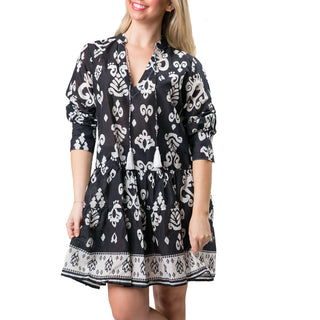 Black and white paisley pattern tiered long sleeve tunic dress with a split neck and tassel ties