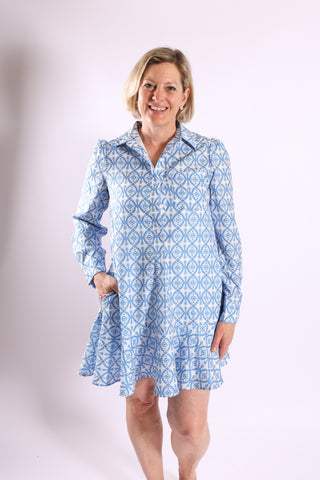 Dottie Dress in blue geometric print with button-down front and flared hem.