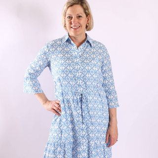 Blue floral Diane Dress with waist tie and button front, side studio image