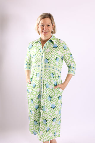 The Lennon Dress in green and blue hydrangea print with geometric design, front view with pockets.