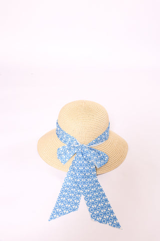 Brigitte Twillie Ribbon Hat with a blue geometric print ribbon tied in a bow.