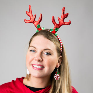 Whimsey headband with red glitter antlers  and red and white striped headband shown on model