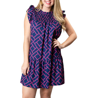 Navy and pink diamond print dress with cap flutter sleeves, smocked above the chest