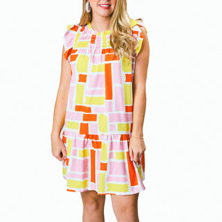 Pink, orange, and yellow block print dress with cap flutter sleeves, smocked above the chest