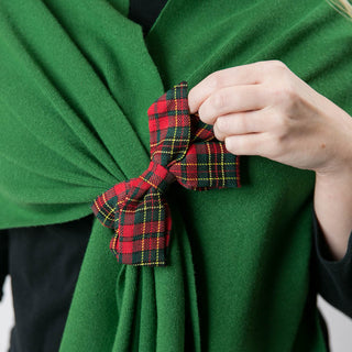close uo of forest green kaden knit keyhole wrap with red and green plaid bow