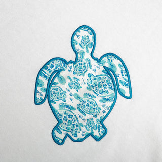 White One Size Poncho with white and blue sea turtle, close up