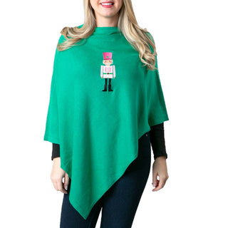 Green poncho with pink nutcracker