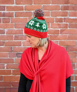 Red and Green Pom Pom Hat with Tree and Snowflake Motif on model