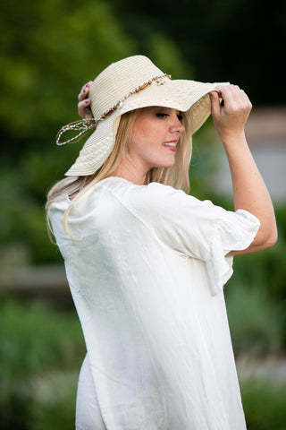 Back view of viscose cover-up with ruffle in white with model wearing beach hat